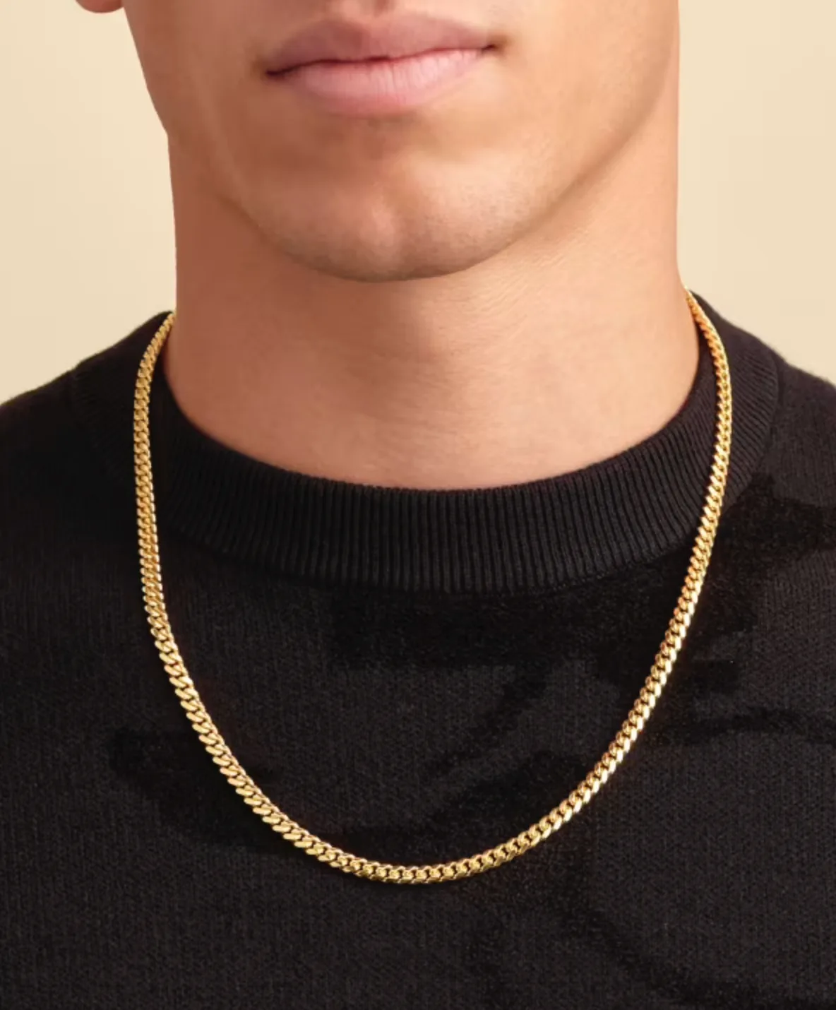 The chain worn over a black knit